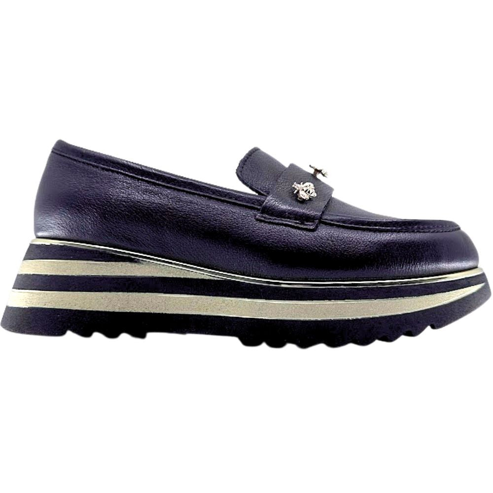 Black loafer with gold bees and a striped gold and black sole on a white background