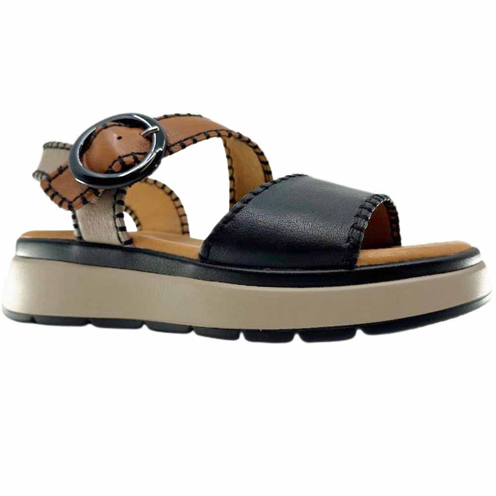 A sandal with black, taupe and tan leather straps with stitched edged detailing and a round buckle, set on a beige platform sole, against a white background.