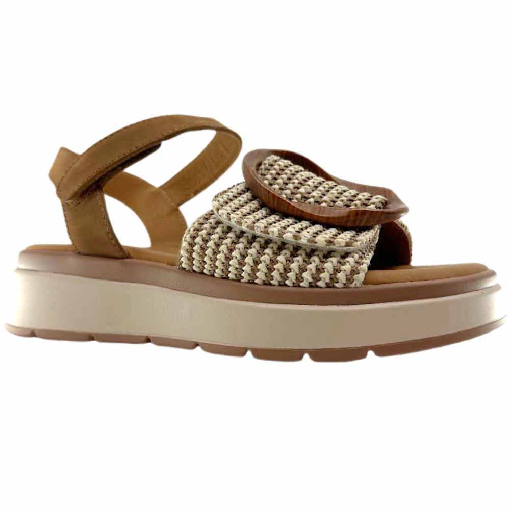 A sandal with a tan and cream woven strap across the vamp with a statement oversized buckle, a tan ankle strap and a beige platform sole against a white background.