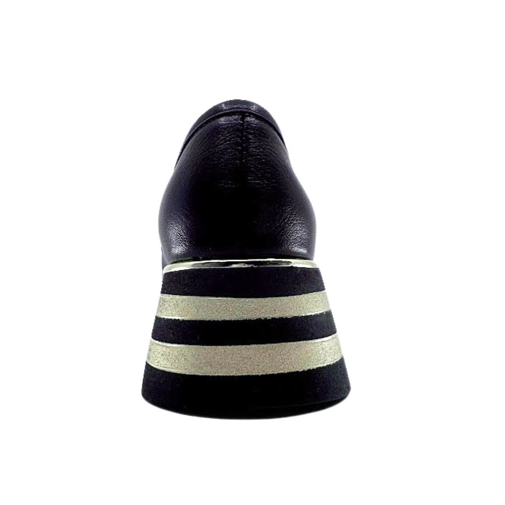 Black shoe with striped black and gold sole on a white background