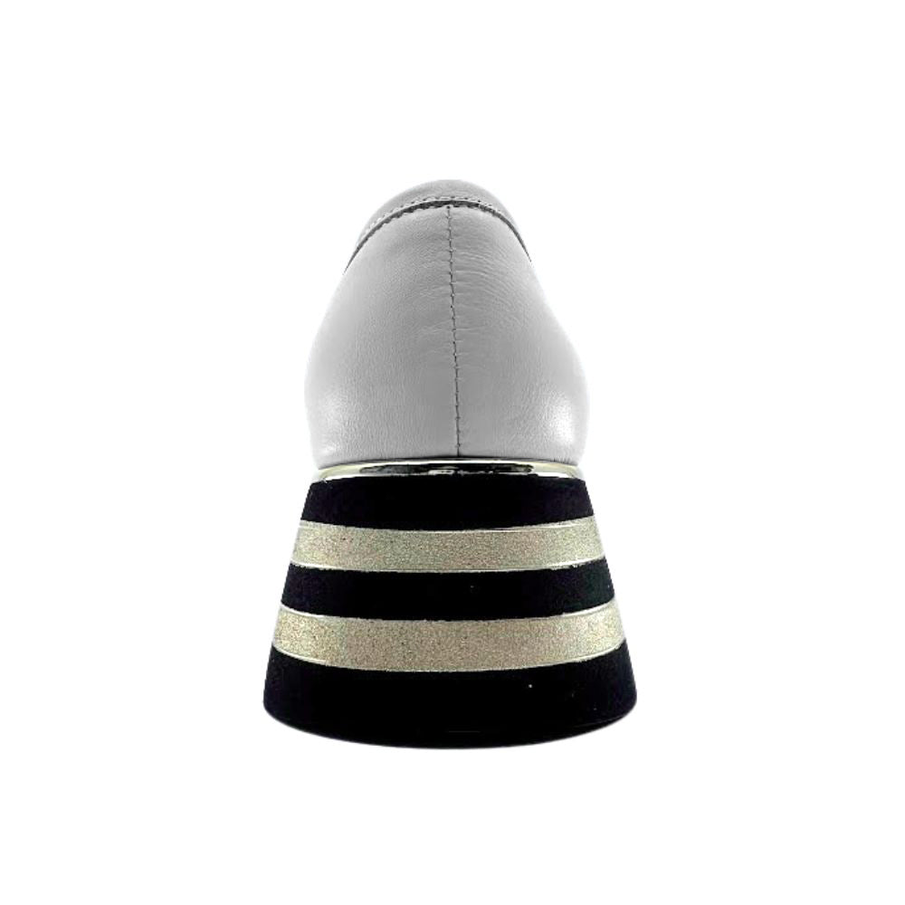 Cream shoe with black and gold striped sole on a white background