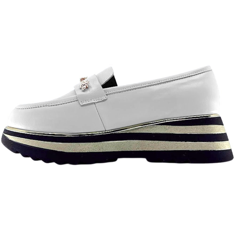 Cream loafer shoe with a striped sole on a white background