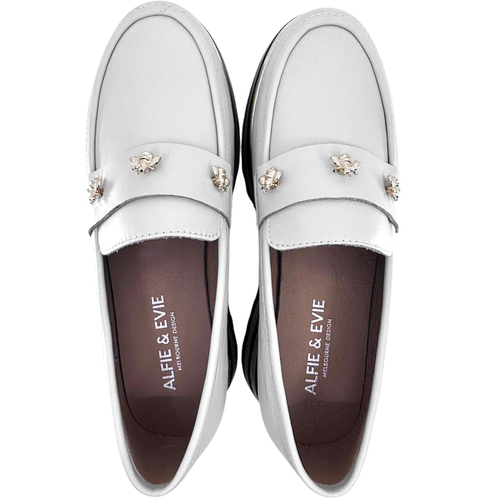 Cream loafers with decorative bee elements on a white background