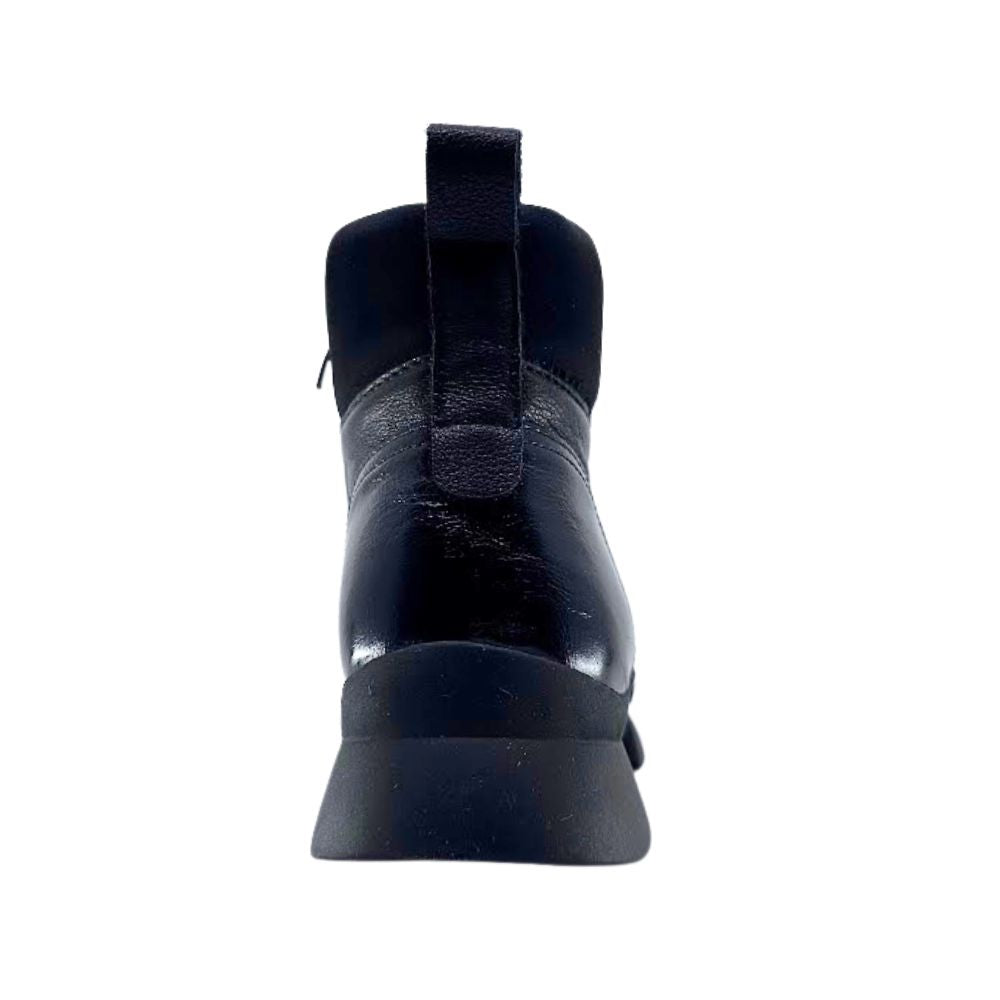 Black ankle boot with a rear pull strap on a white background