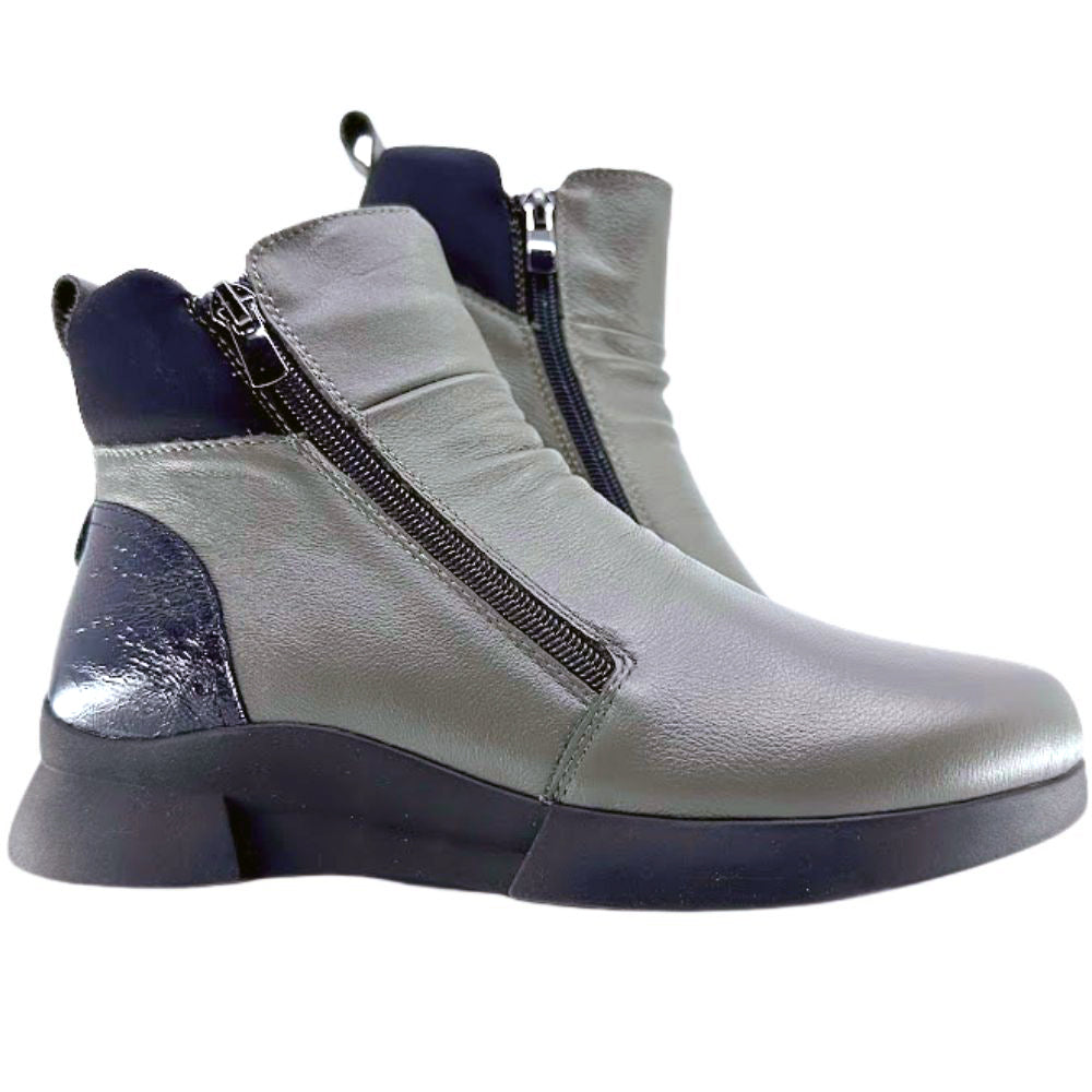 Khaki and black ankle boots with a zipper on a white background