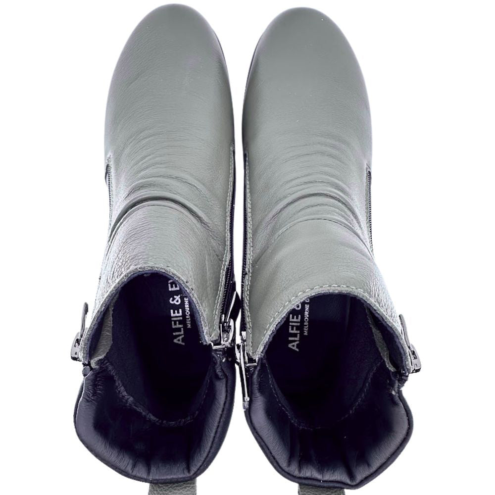 Pair of Khaki ankle boots with zippers on a white background