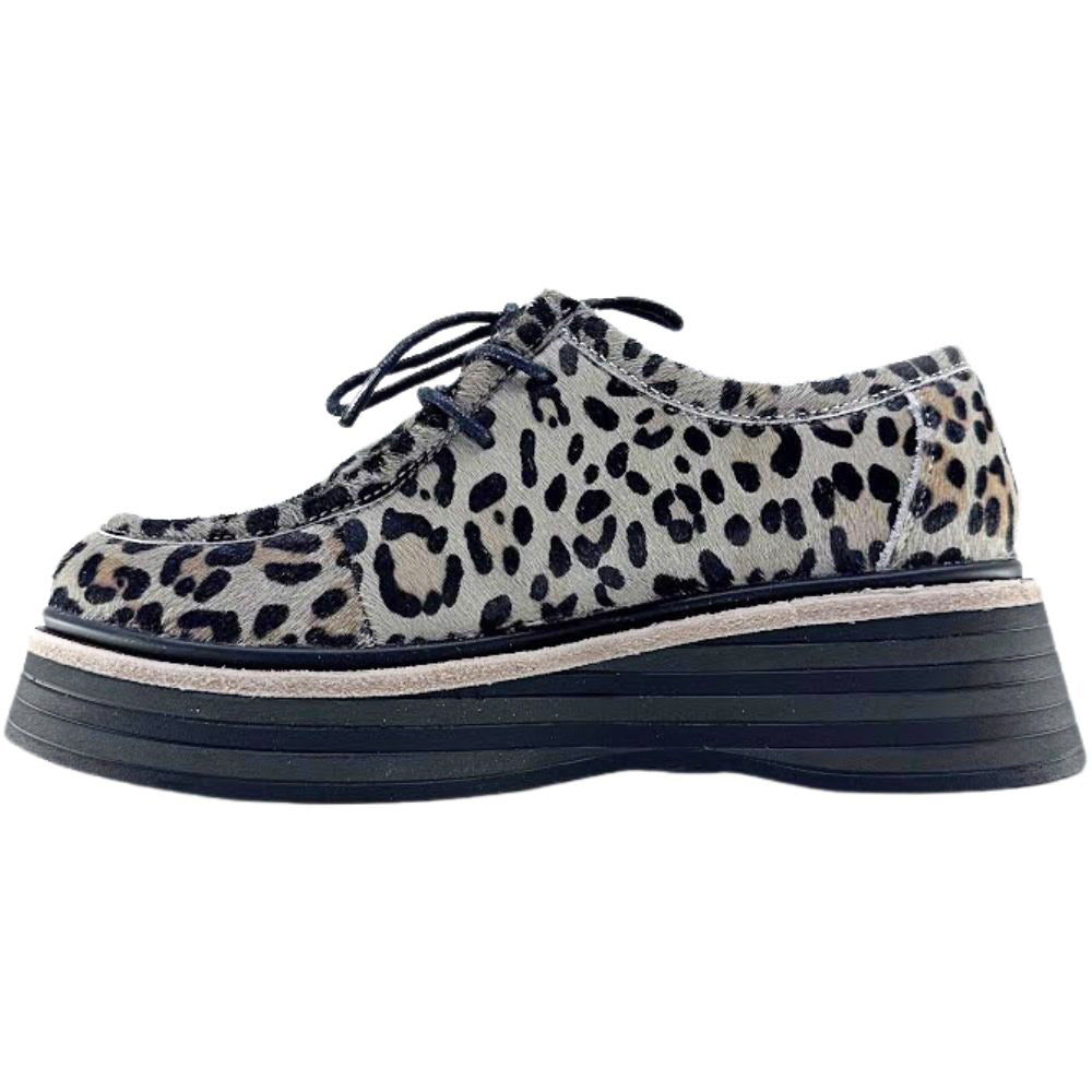 Leopard print shoe with a thick sole on a white background