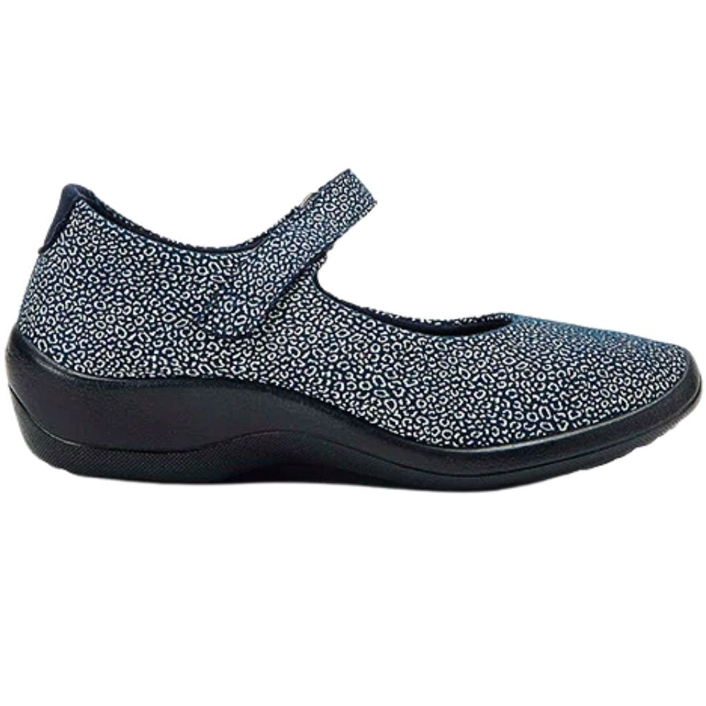A single women's Mary Jane style shoe shown in profile against a plain white background. The upper features a dark navy blue base covered in a dense, small-scale light speckled pattern, while the sole is solid black.