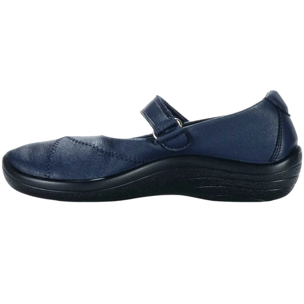 A navy blue Mary-Jane style shoe with a black sole, shown in a side profile view against a plain white background.