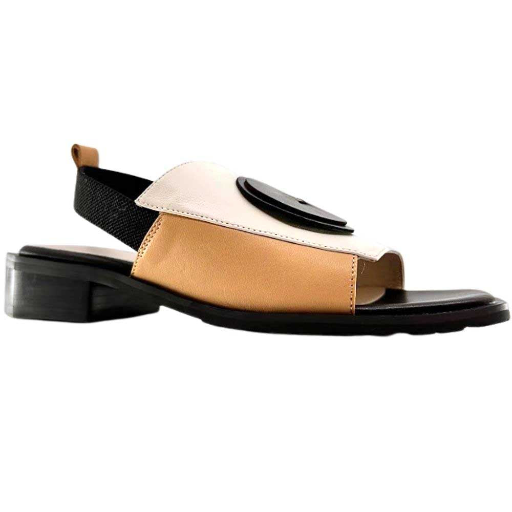 A women's slide sandal with a low block heel, featuring a color-blocked design in tan, cream, and black, with a black leather disk detail on the toe strap.
