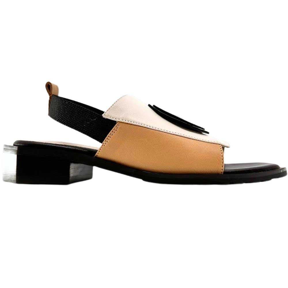 A women's slide sandal with a low block heel, featuring a color-blocked design in tan, cream, and black, with a black leather disk detail on the toe strap.