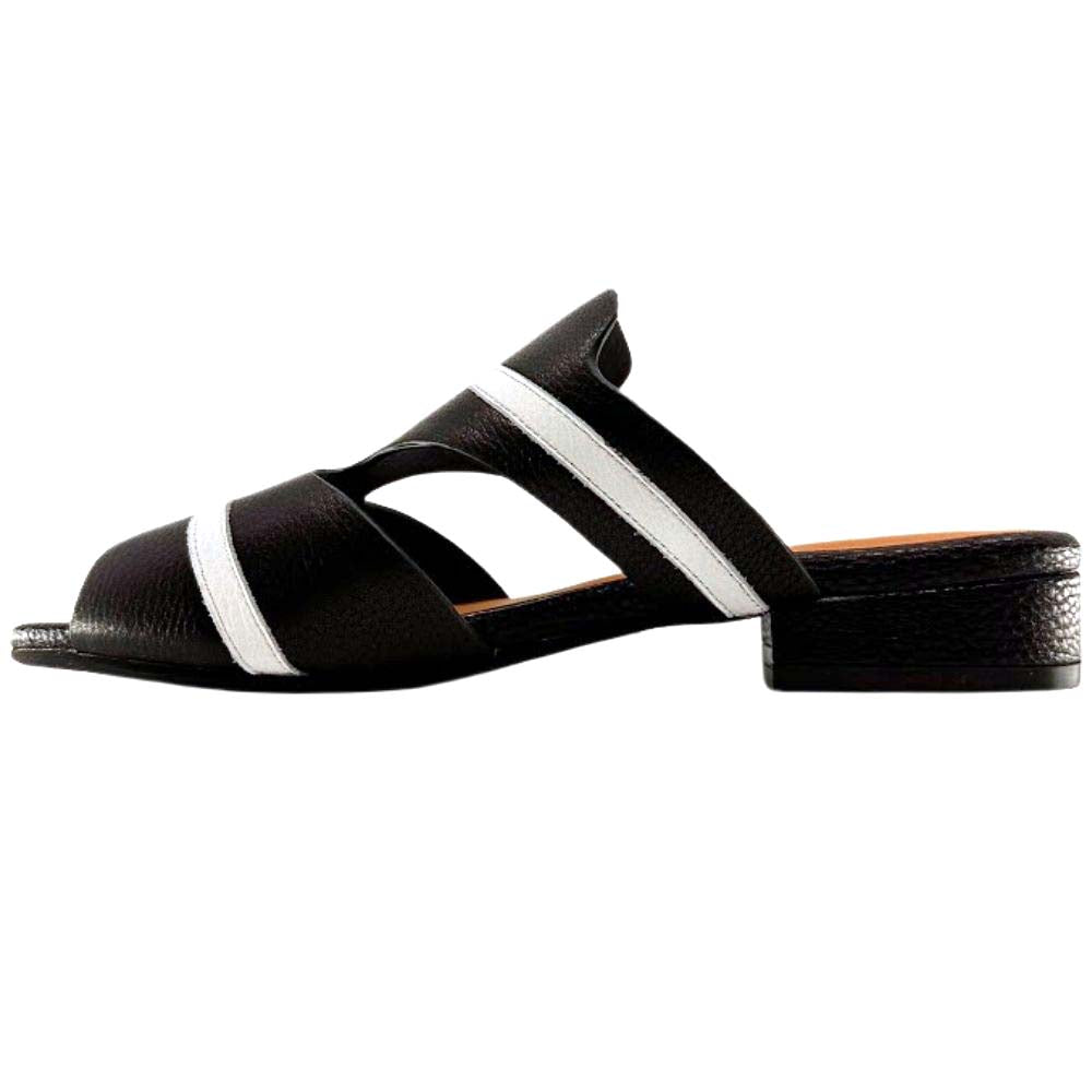 The inside of a black leather slip-on sandal with white horizontal stripes and a low block heel, against a white background.
