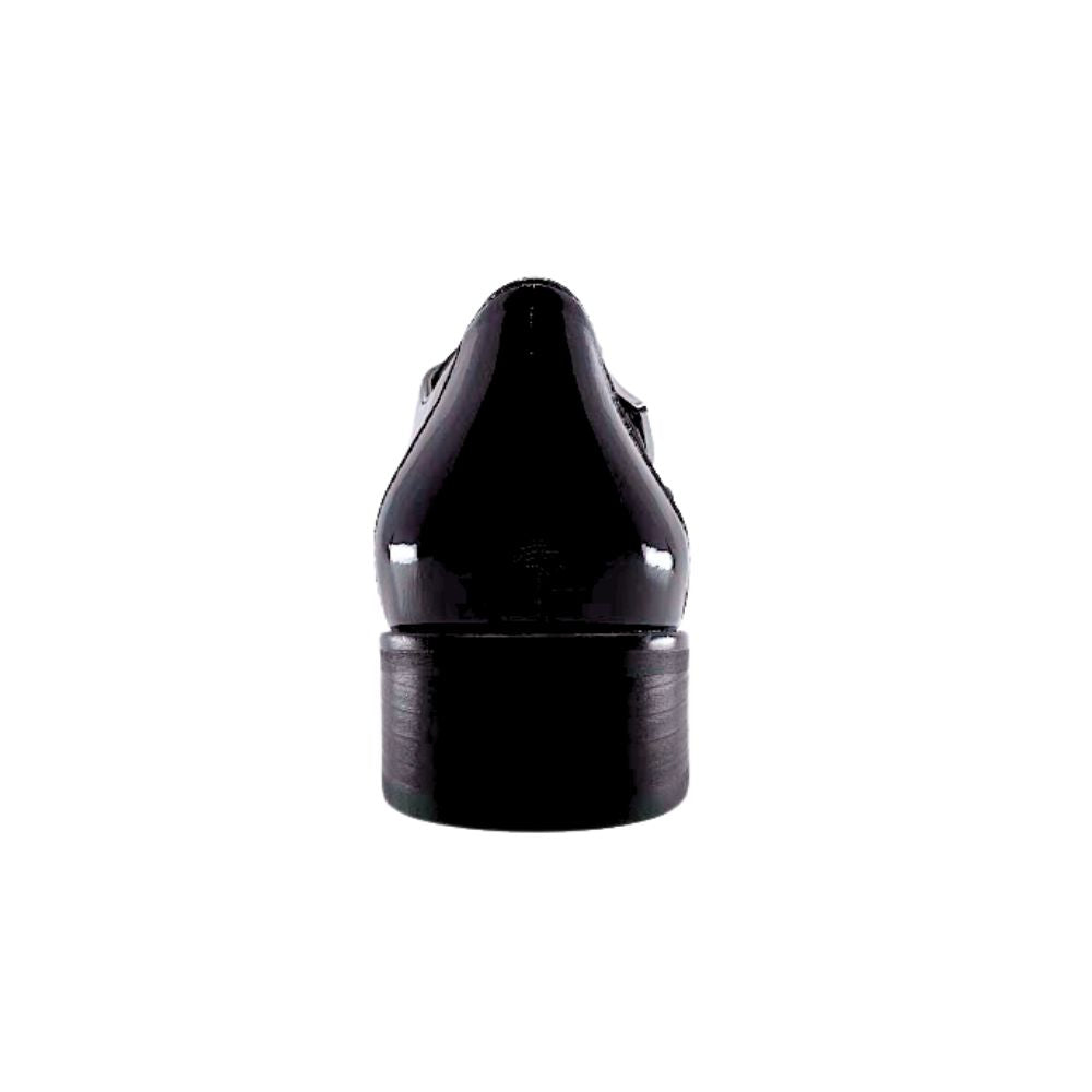 Back of black patent shoe on a white background
