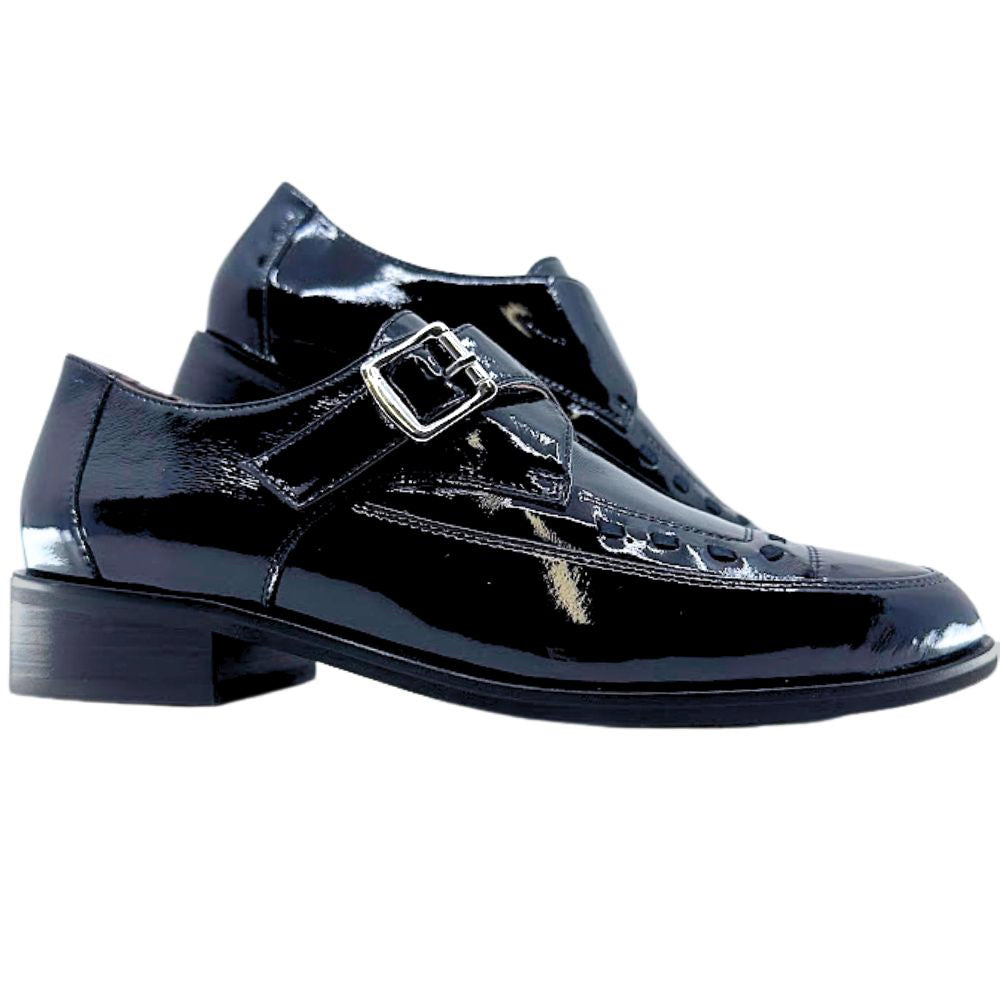 Black patent leather dress shoe with a buckle on a white background