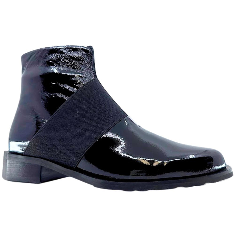 Black patent leather ankle boot with an elastic strap on a white background