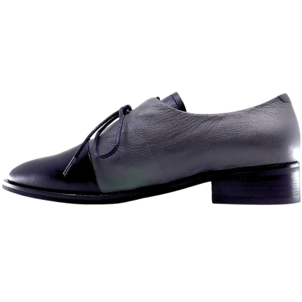 Grey and black leather shoe with a black sole on a white background
