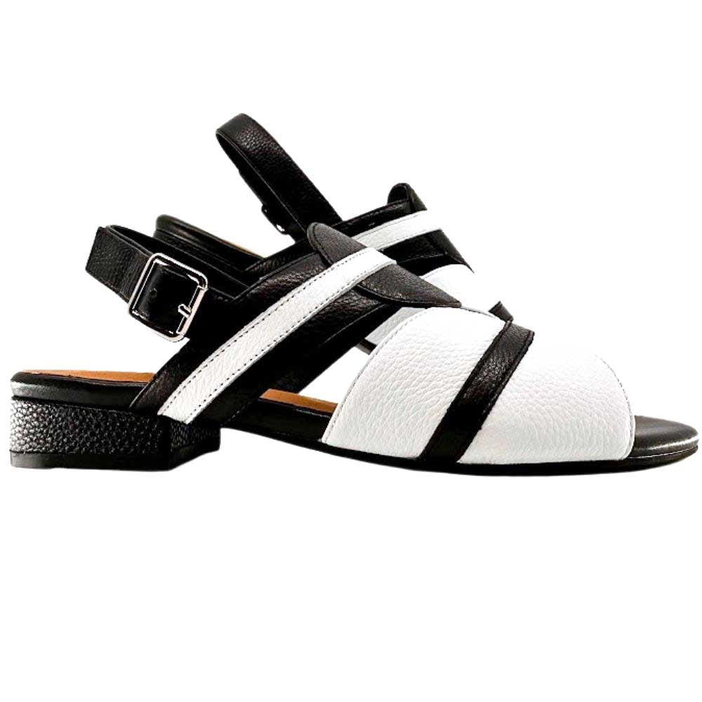 Pair of black and white leather sandals with a low block heel and an ankle strap on a white background