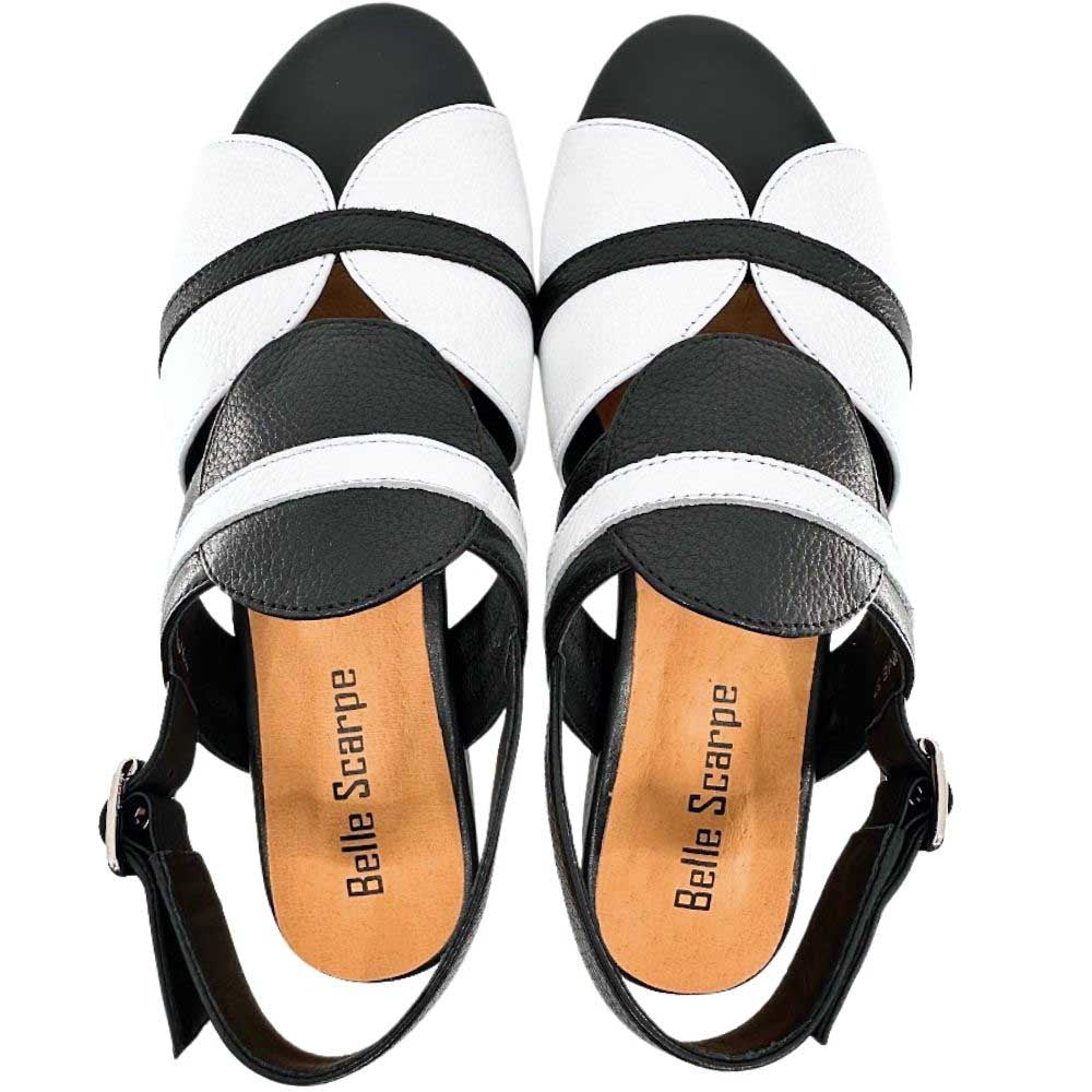 Black and white leather slingback sandals with adjustable buckle straps, shown in a top-down profile on a white background.