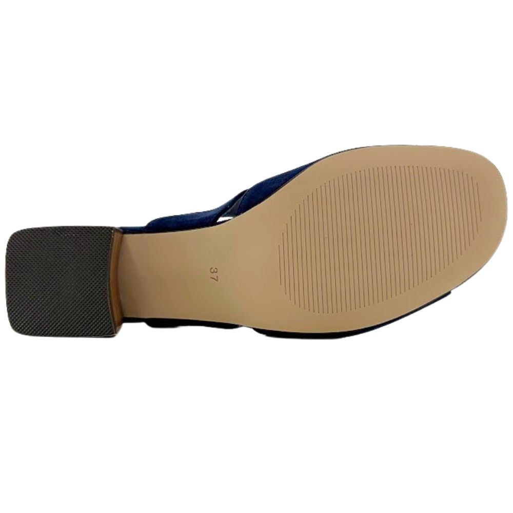 Top-down view of a shoe sole showing a navy blue upper, a beige rubber outsole, and a black textured heel block on a white background.