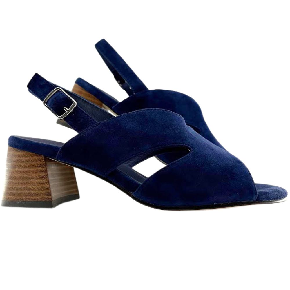 A pair of navy blue suede slingback sandals with cutout details on the toe and instep, featuring a chunky wooden block heel and a silver buckle.