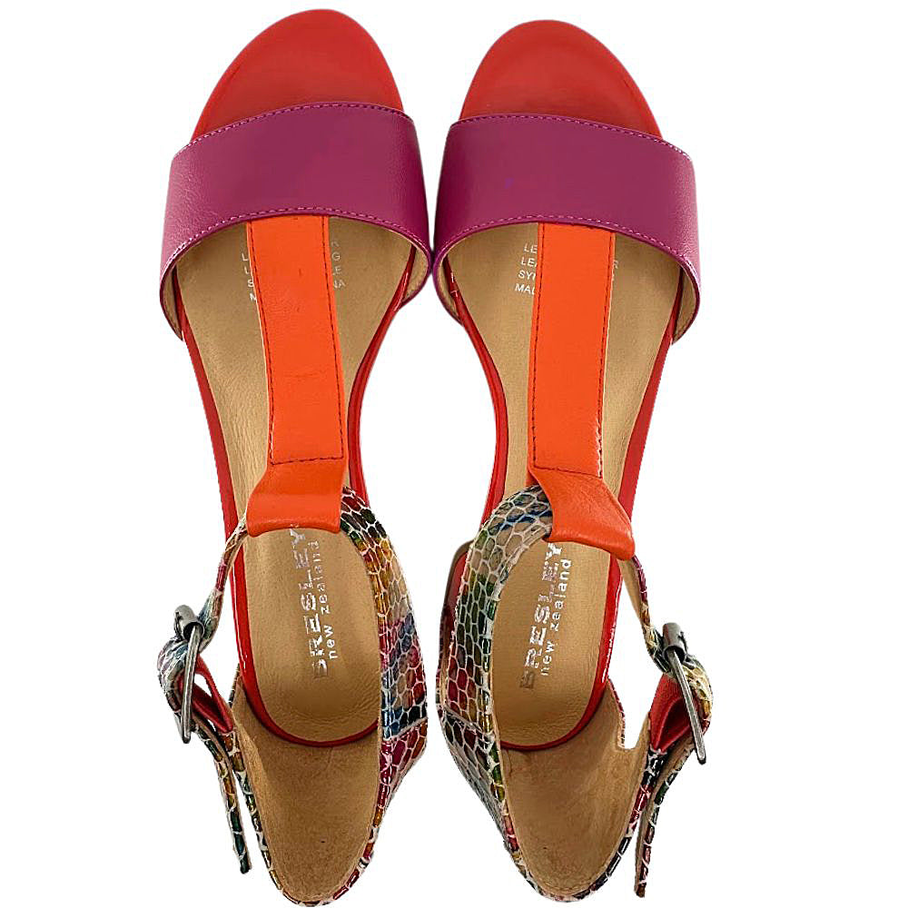 Pair of colorful sandals with pink straps and multicolored soles on a white background