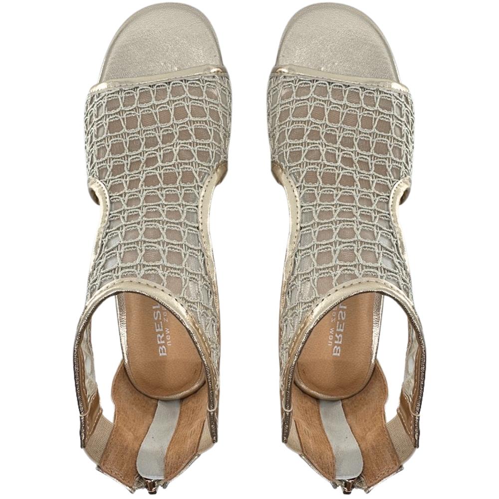 A top-down view of a pair of gold mesh and leather 'Bresley' heeled sandals with a T-strap design and rear zip, against a white background.
