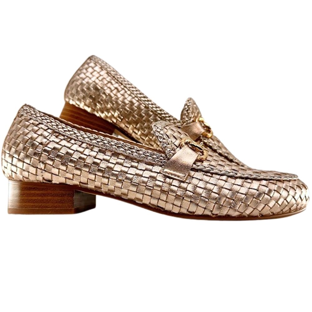 A pair of woven loafers in a metallic rose gold finish with a low wooden block heel, shown against a plain white background.