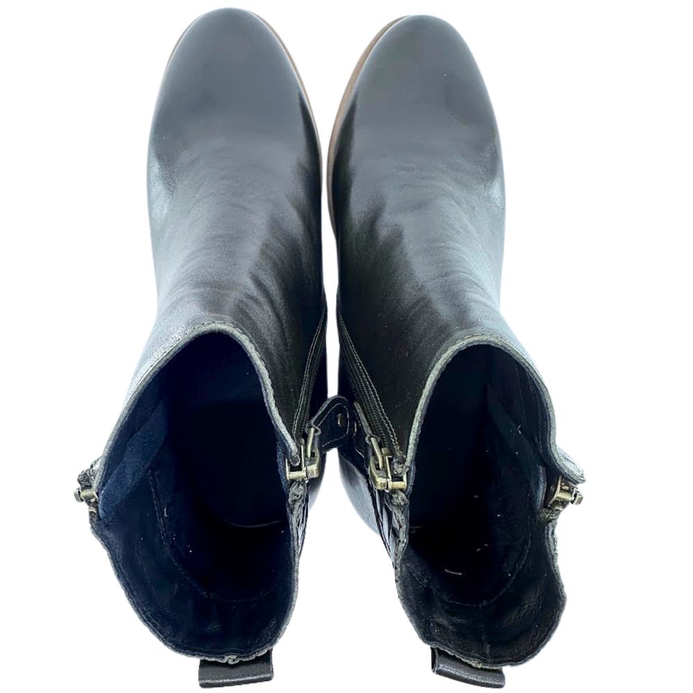 Pair of dark forest green leather ankle boots with gold zipper on a white background