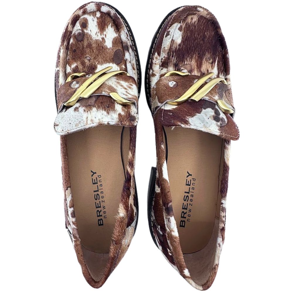 Pair of Bresley loafers with brown and white animal print pattern on a white background