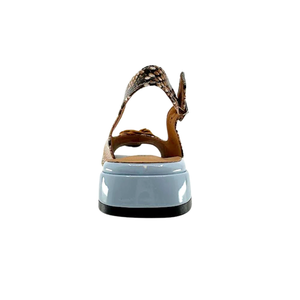 A single sandal shown from the back, featuring a glossy light blue heel, and a brown and black snakeskin-patterned ankle strap, set against a plain white background.
