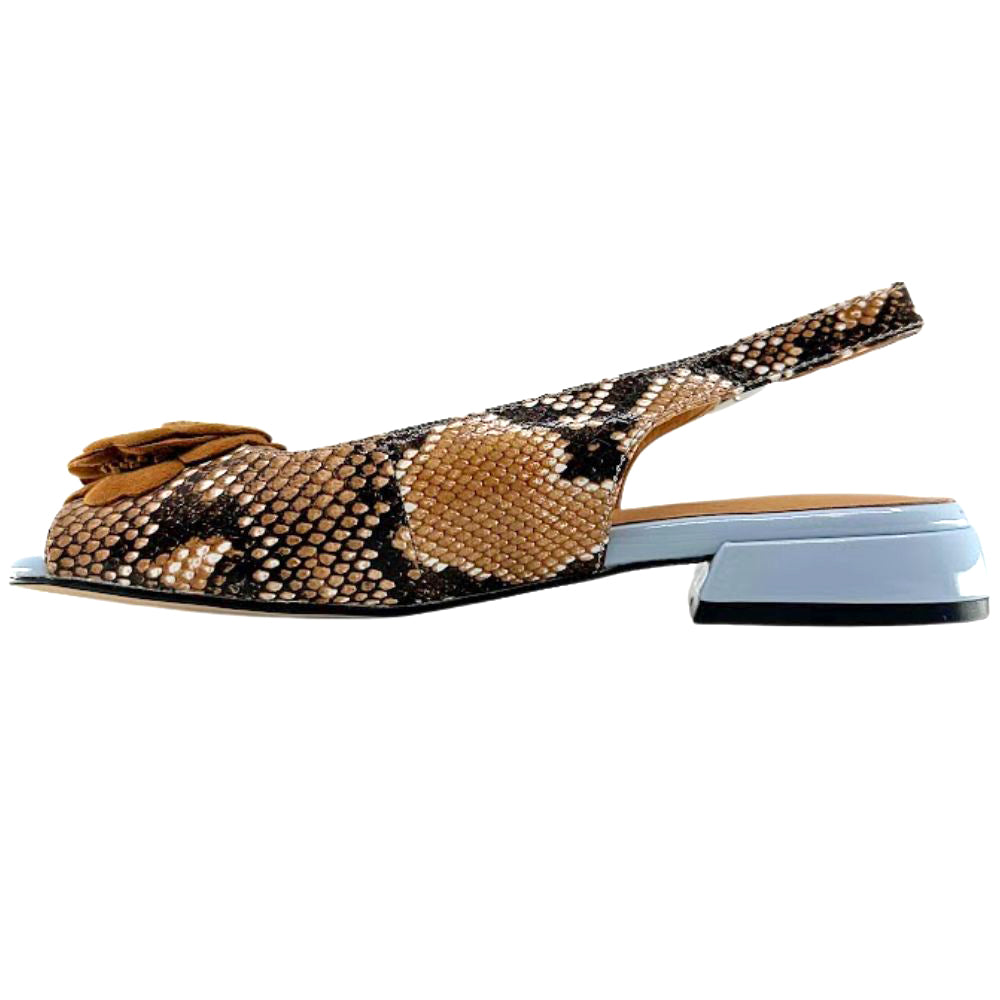 A single women's slingback flat shoe featuring a brown and black snakeskin pattern upper with a tan suede flower detail on the toe, set against a light blue block heel on a white background.