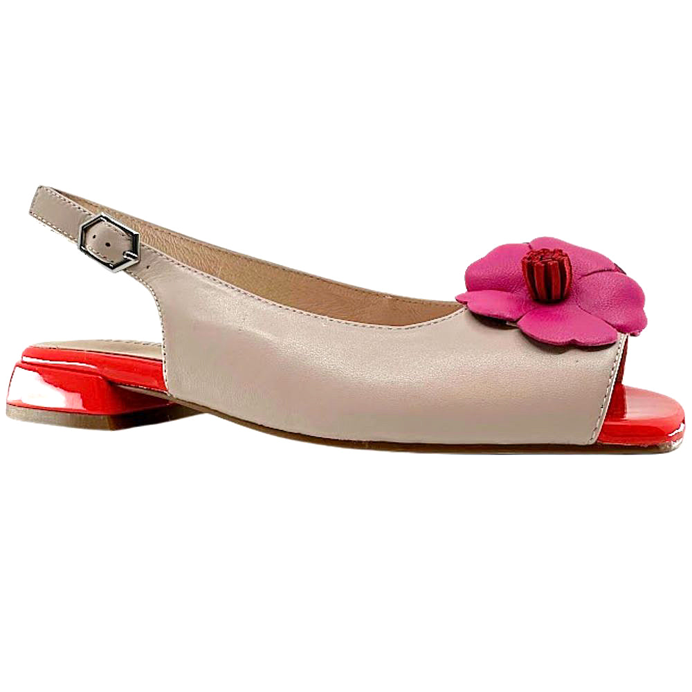 A single women's slingback flat sandal in light beige leather with a bright pink flower embellishment on the toe area and a glossy red block heel, shown against a plain white background.
