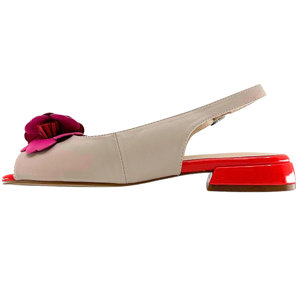 A beige leather slingback flat sandal with a bright pink flower embellishment on the toe and a glossy red block heel, shown in a side profile against a white background.