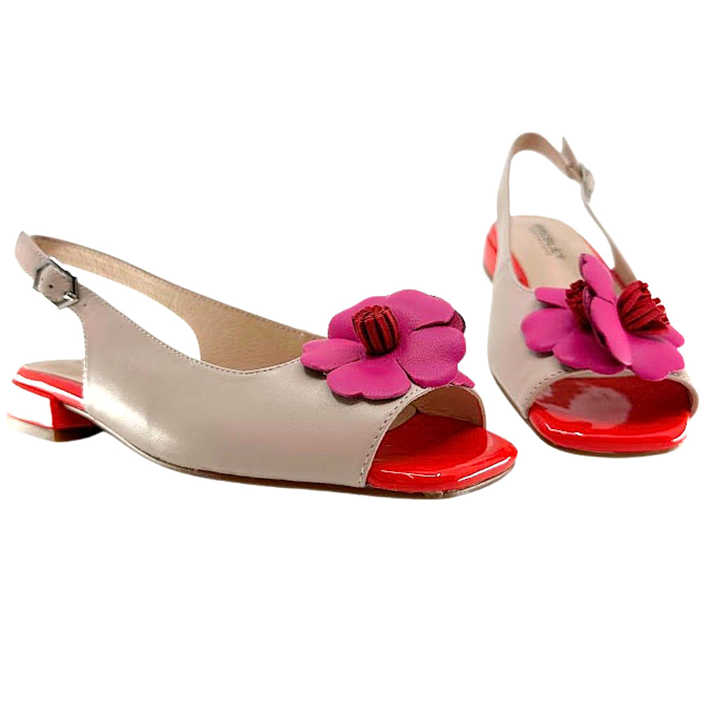 A pair of women's slingback sandals in beige leather with large pink flowers on the toes and bright red soles, shown against a plain white background.
