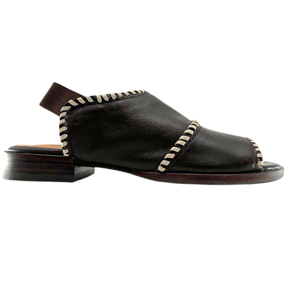 A single dark brown leather sandal with a low block heel, featuring decorative cream braided trims, shown against a plain white background.