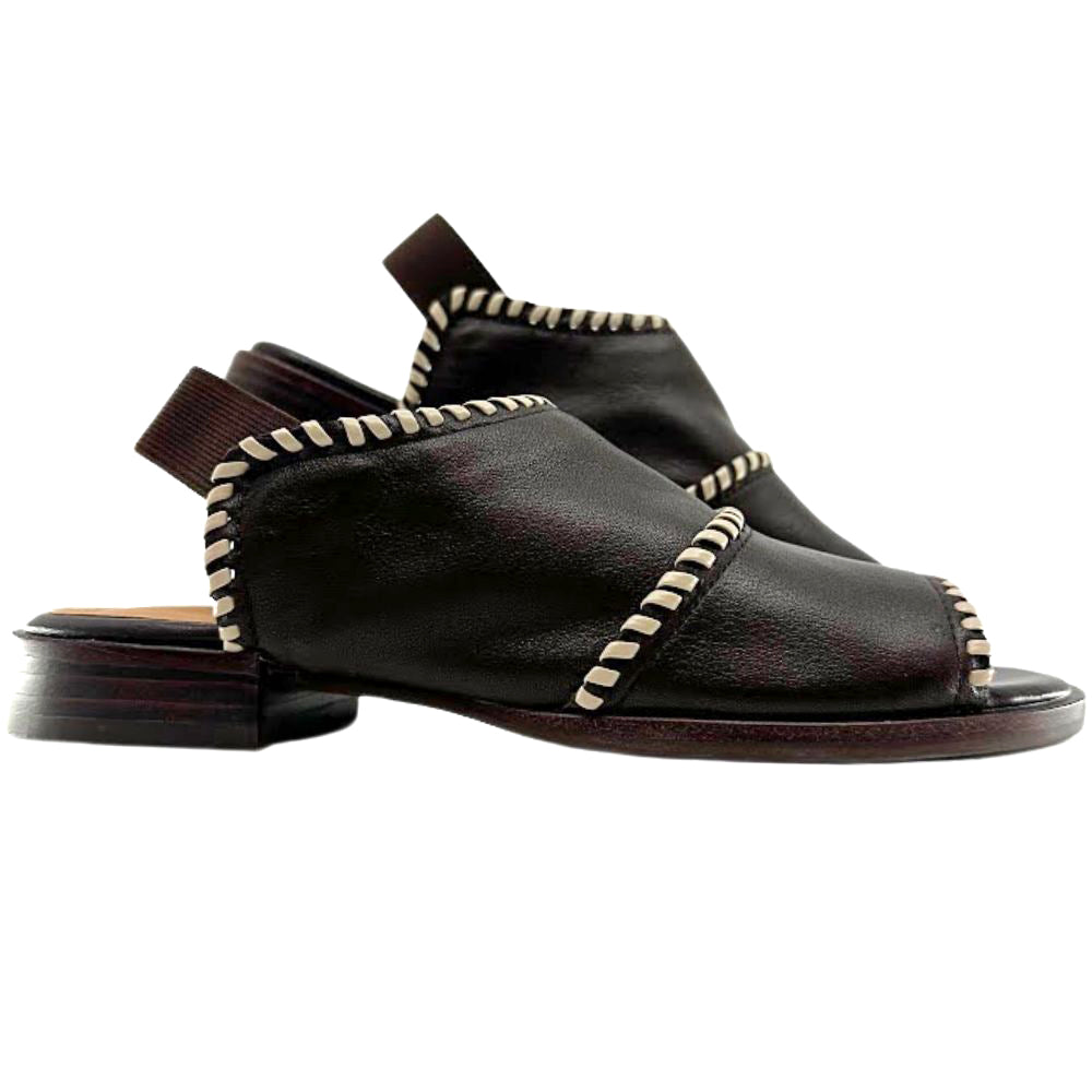 A pair of dark brown leather sandals with peep-toe, decorative cream-colored whipstitching along the straps and heel pull tabs, shown against a plain white background.