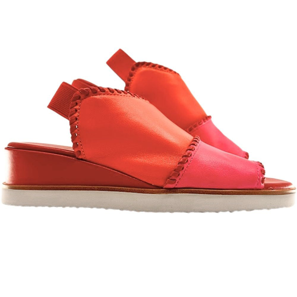 A pair of women's wedge sandals in vibrant shades of coral orange, hot pink, and red, shown against a white background.