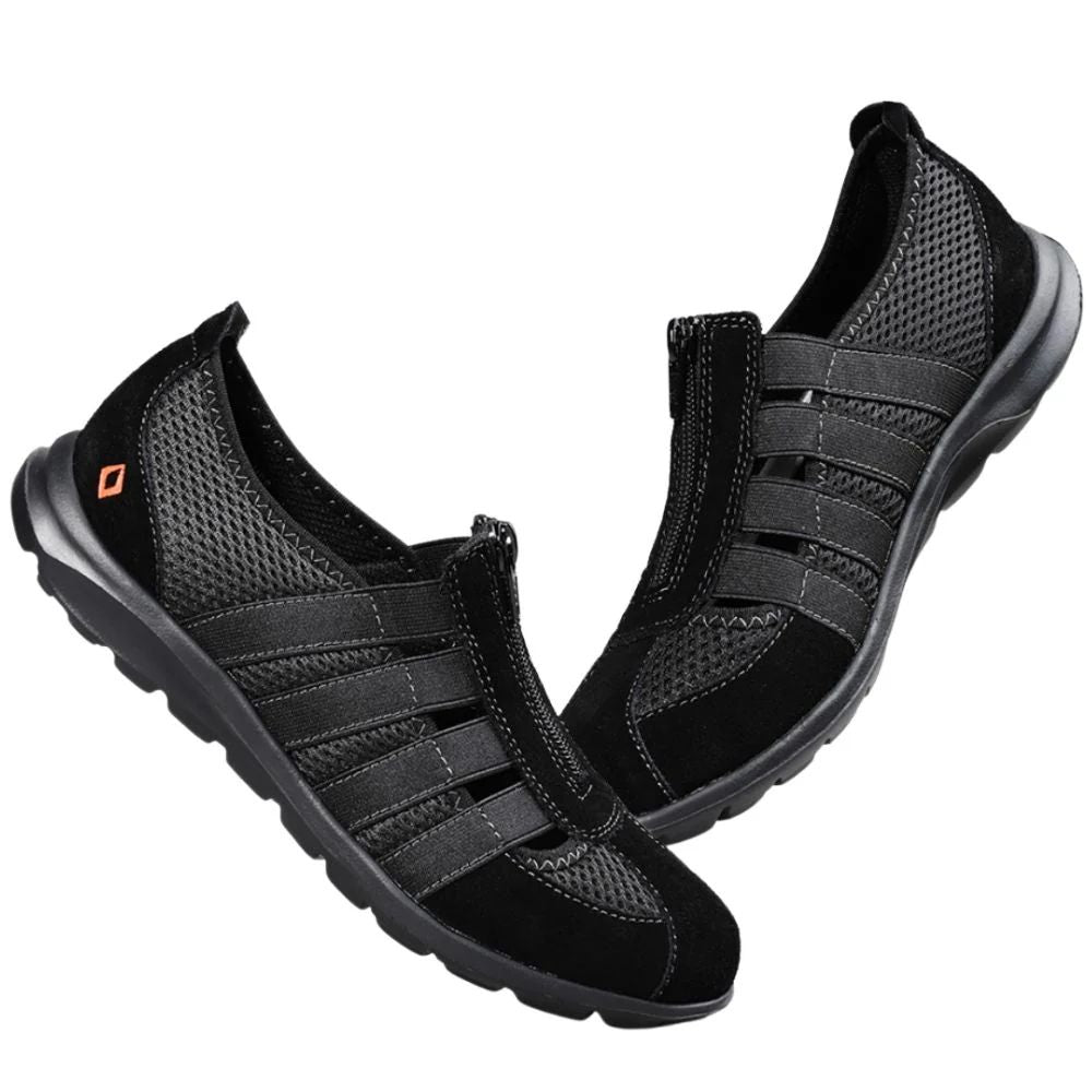 Black slip-on shoes with mesh design on a white background