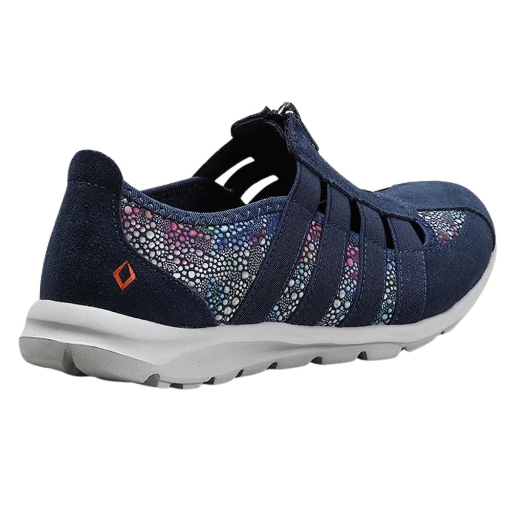 A navy blue slip-on walking shoe with a suede leather and textile upper, colorful  side panels, central zip, a white sole, and a small orange logo on the heel.