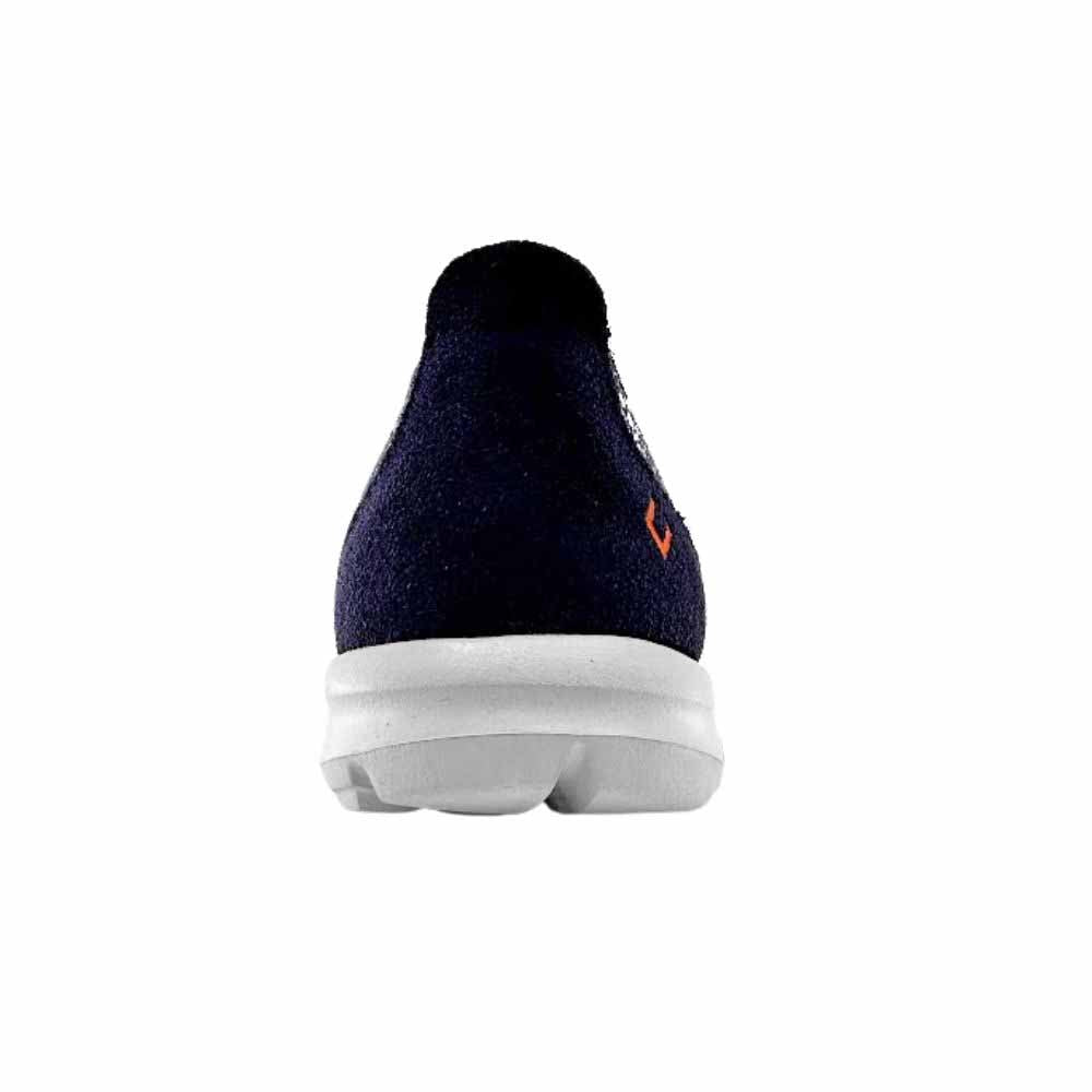 A single dark navy blue slip-on shoe shown from the back, featuring a suede upper, a small orange logo on the side, and a thick white sole, set against a plain white background.