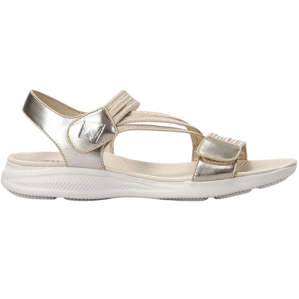A metallic champagne gold women's sandal with multiple elastic woven straps and a thick white cushioned sole, shown in a side profile on a white background.