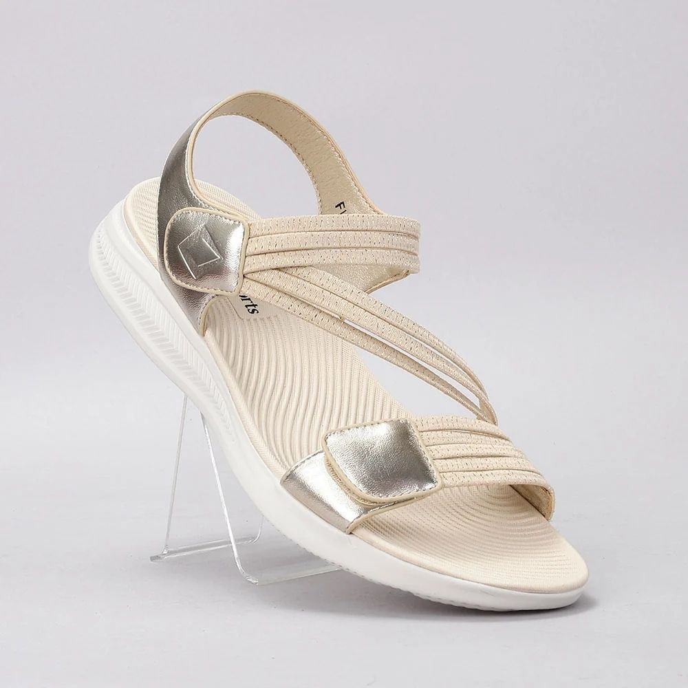 A single women's wedge sandal in cream and metallic gold, displayed on a clear acrylic stand against a light gray background.