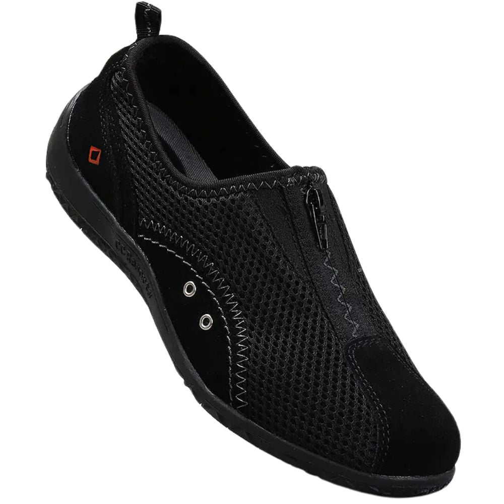 Black slip-on shoe with central zipper on a white background