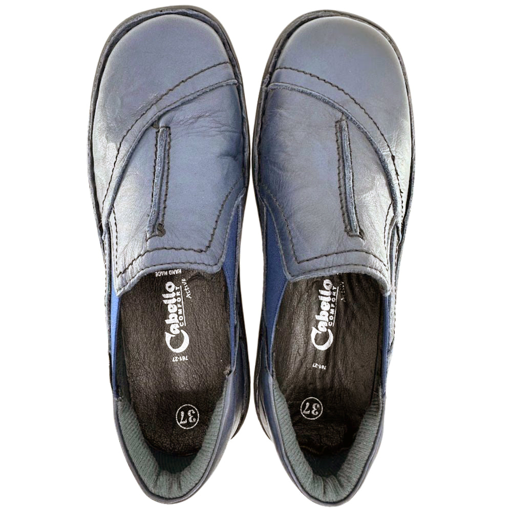 Pair of navy leather slip-on shoes with 'Cabello' branding on a white background