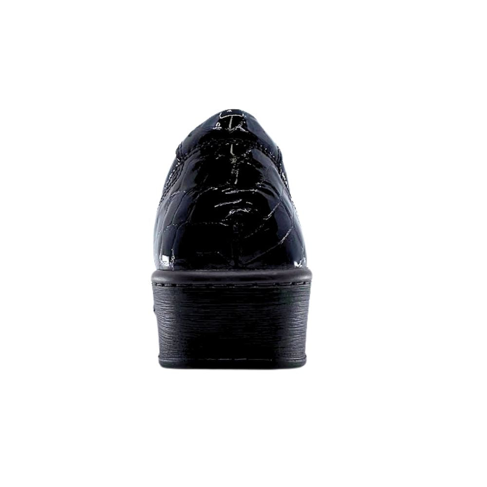 Black patent leather shoe on a white background