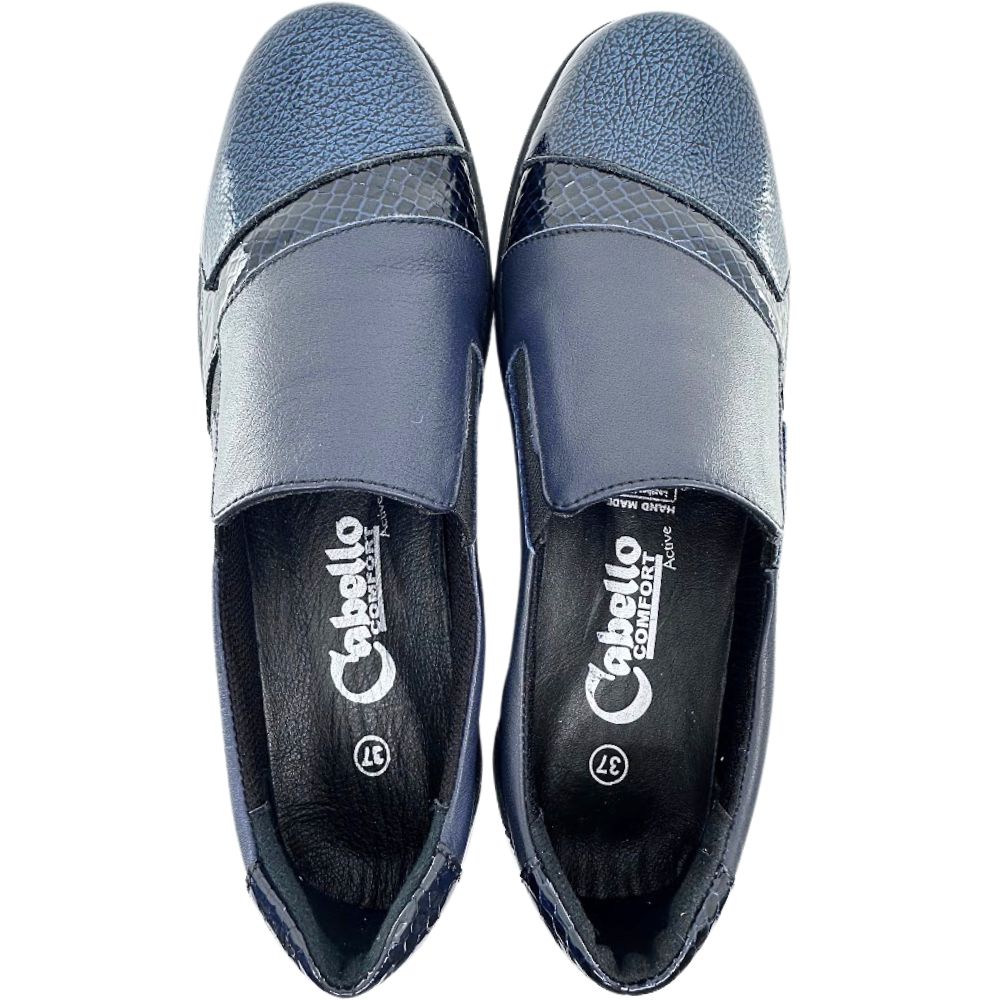 Pair of navy slip on shoes with 'Cabello' branding on a white background
