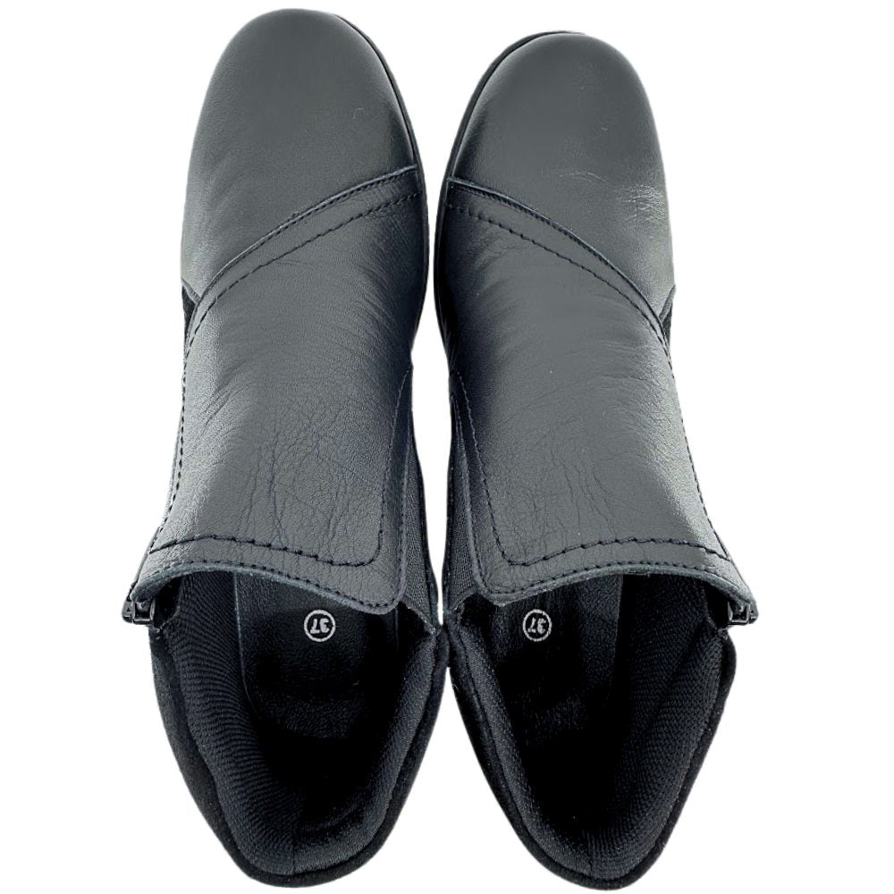 Pair of black leather ankle boots on a white background