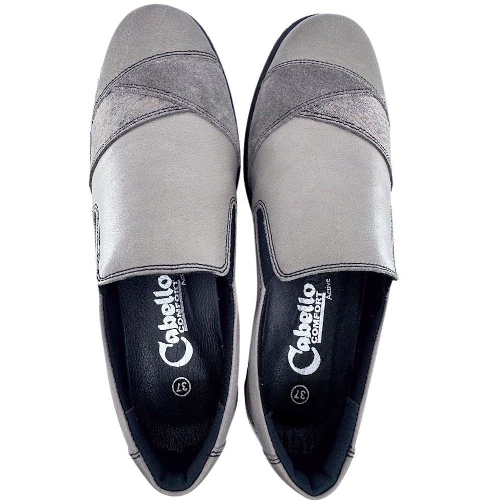 Pair of taupe slip-on shoes with 'Cabello' branding on a white background