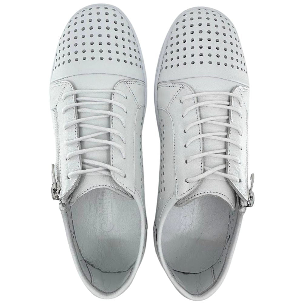 A top-down view of a pair of white sneakers with a perforated Turkish leather upper, side zip entry and lace-up adjustment, against a white background.