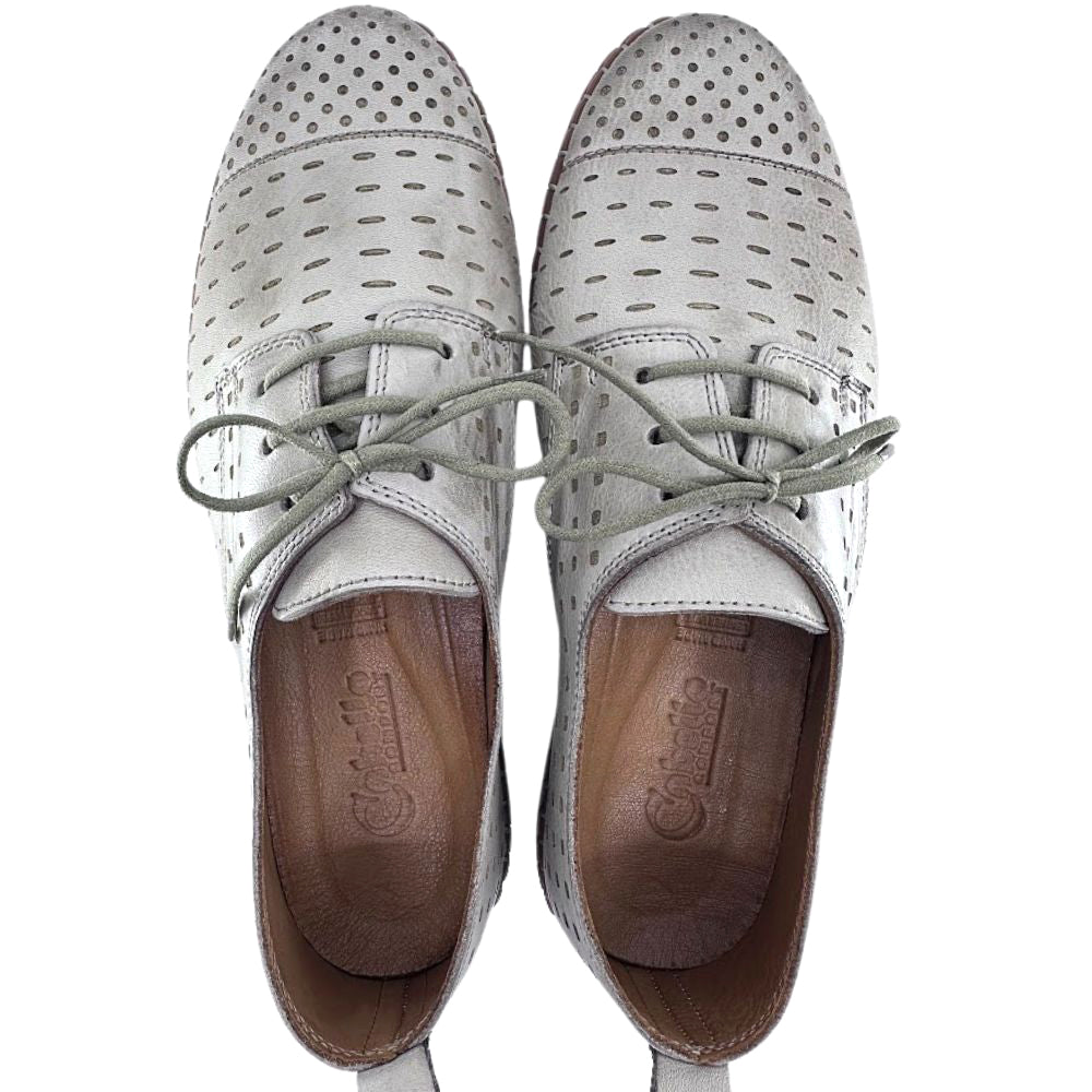 Pair of taupe perforated shoes with brown soles on a white background